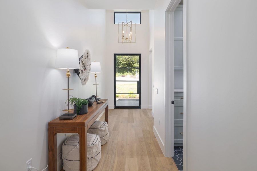 Entryway featuring a double-height ceiling and wood-finish flooring