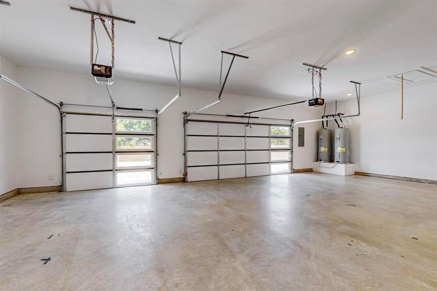 Garage with electric water heater, a garage door opener, and electric panel