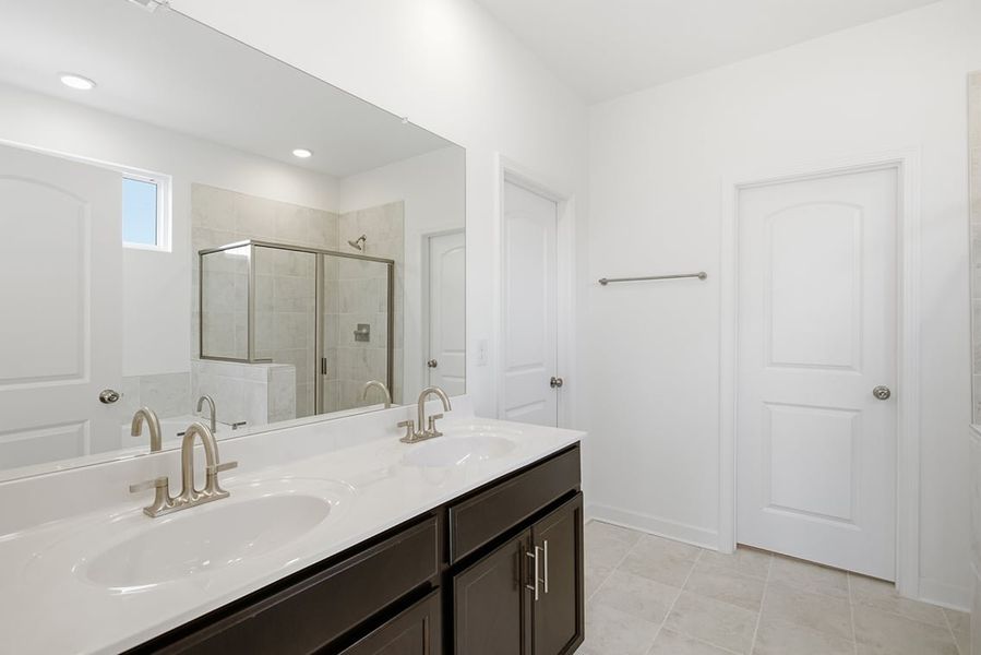 A bathroom with a large mirror. A bathroom with a large mirror.