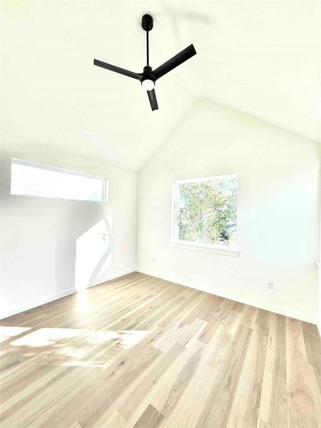 Bonus room featuring vaulted ceiling, light wood-type flooring, and a ceiling fan