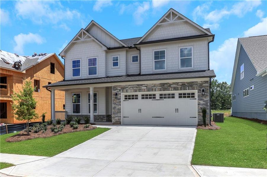 Front exterior of a new home in Twin Lakes, Hoschton, GA, highlighting curb appeal (Image 27). Front exterior of a new home in Twin Lakes, Hoschton, GA, highlighting curb appeal (Image 27).