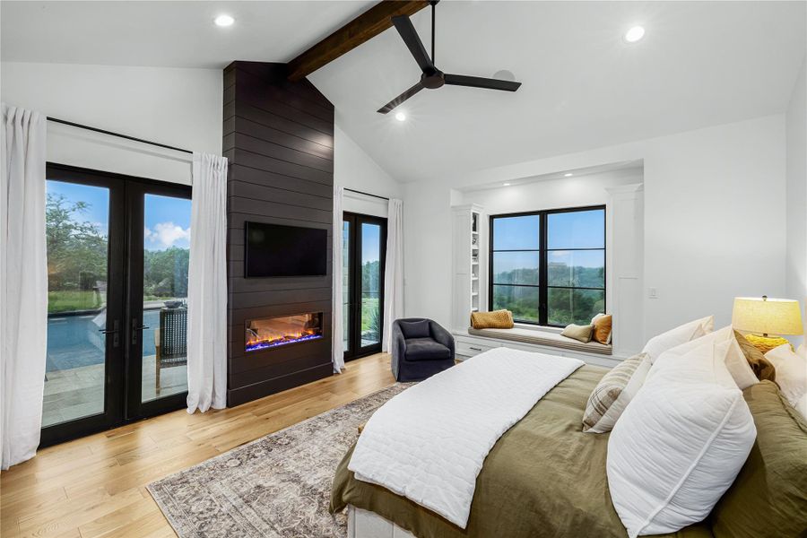 Bedroom featuring ceiling fan, vaulted ceiling with beams, access to outside, french doors, and light wood-type flooring