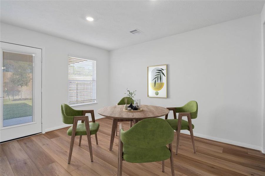 Start your day off right with a cup of coffee sitting with your family in the lovely breakfast/dining area! Featuring a large window with privacy blinds, custom neutral paint, vinyl plank flooring, recessed lighting and high ceilings!