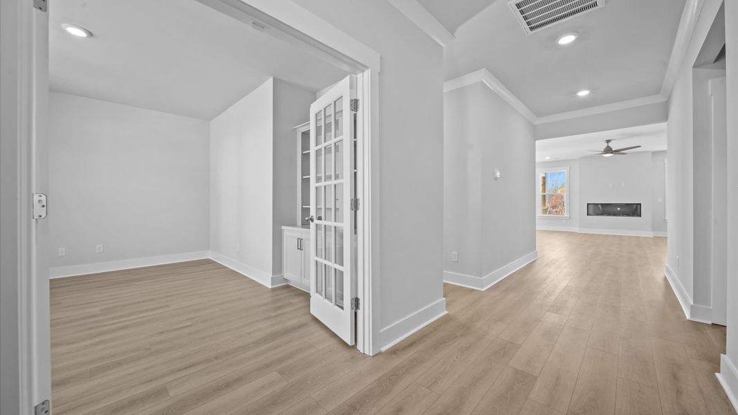 Highly functional foyer with hardwood flooring that flows seamlessly into living spaces