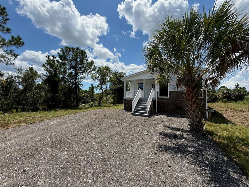 Front exterior of a new home in , Punta Gorda, FL, highlighting curb appeal (Image 2). Front exterior of a new home in , Punta Gorda, FL, highlighting curb appeal (Image 2).