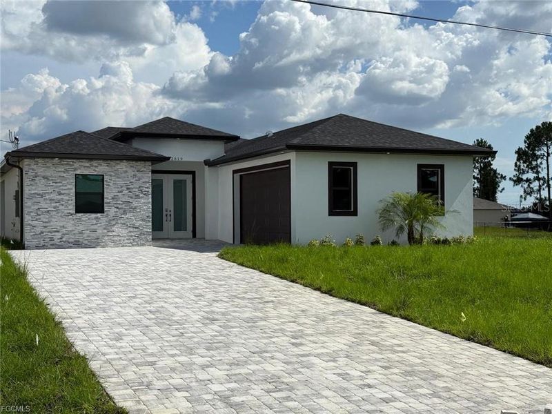Front exterior of a new home in , Lehigh Acres, FL, highlighting curb appeal (Image 12).