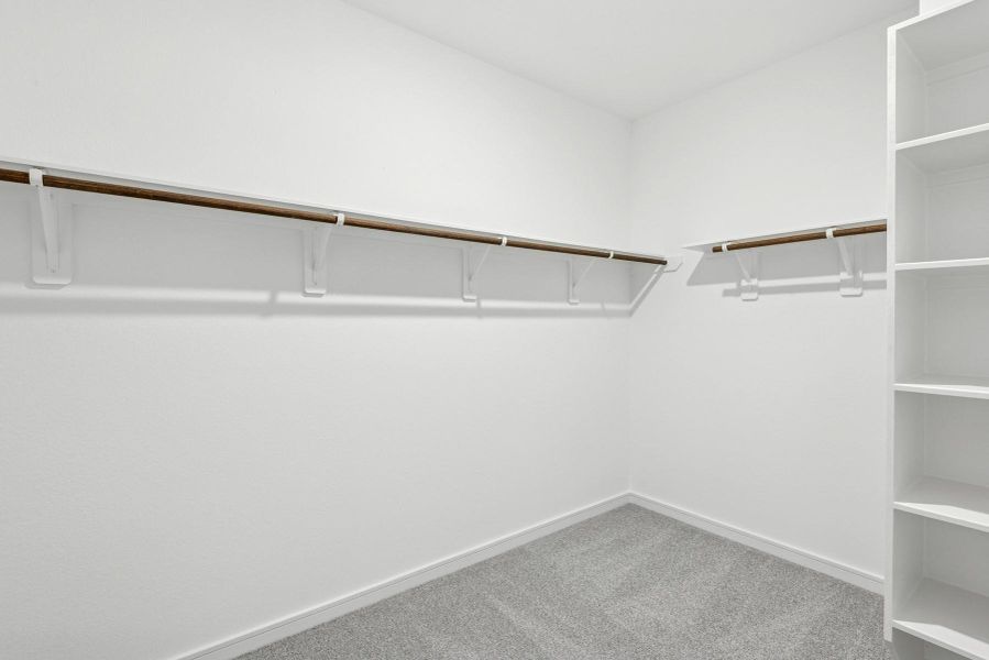 Walk-in closet in the primary suite (*Photo not of actual home and used for illustration purposes only.)
