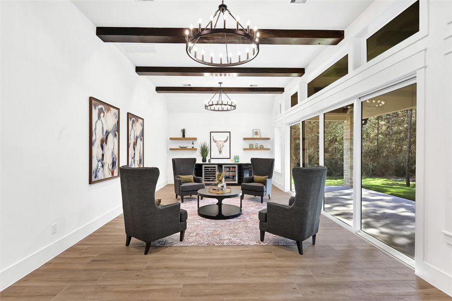 Game Room located off of the breakfast nook on the main level with custom lighting and a wall of windows