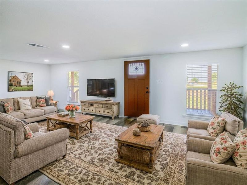 Virtually Staged Living area featuring healthy amount of natural light, recessed lighting, and wood finished floors Virtually Staged Living area featuring healthy amount of natural light, recessed lighting, and wood finished floors