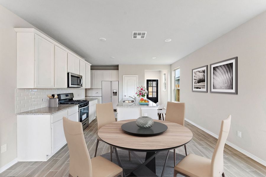 A kitchen with a dining table.