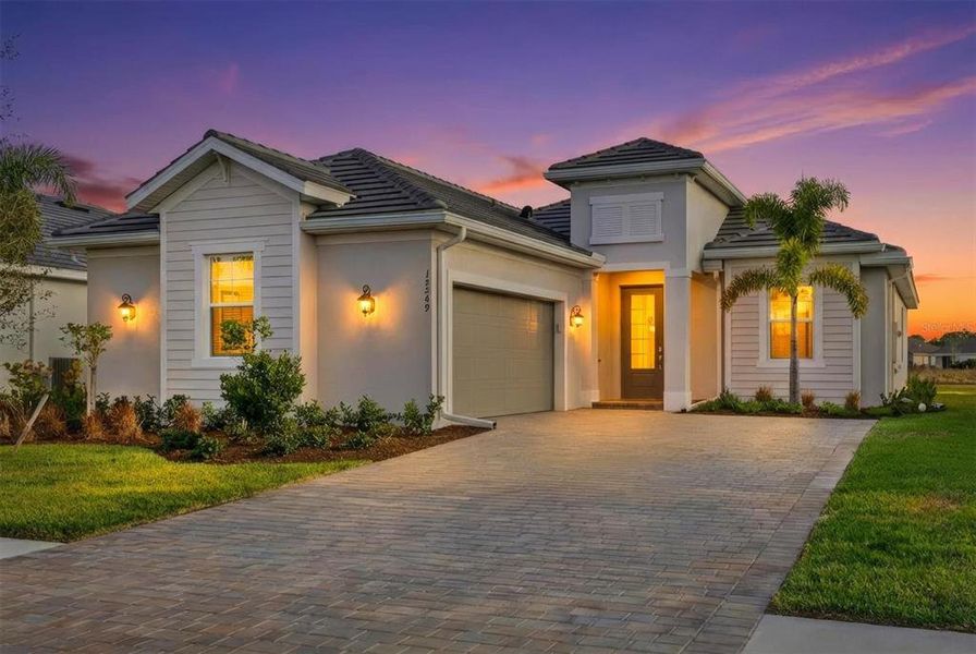 Front exterior of a new home in Heritage Landing, Punta Gorda, FL, highlighting curb appeal (Image 30).