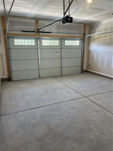 A spacious garage featuring a functional garage do