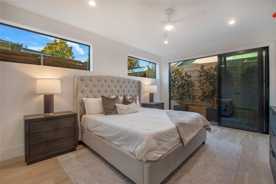 Bedroom with ceiling fan, access to exterior, and light wood-type flooring