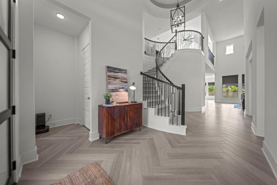 Curved staircase with iron railing creates a standout feature in the entryway. A striking yet comfortable introduction to the home. Curved staircase with iron railing creates a standout feature in the entryway. A striking yet comfortable introduction to the home.
