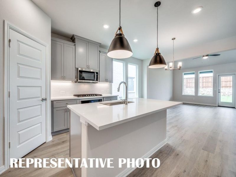 The dining and family rooms are open to the kitchen creating a home that was designed for entertaining!  REPRESENTATIVE PHOTO