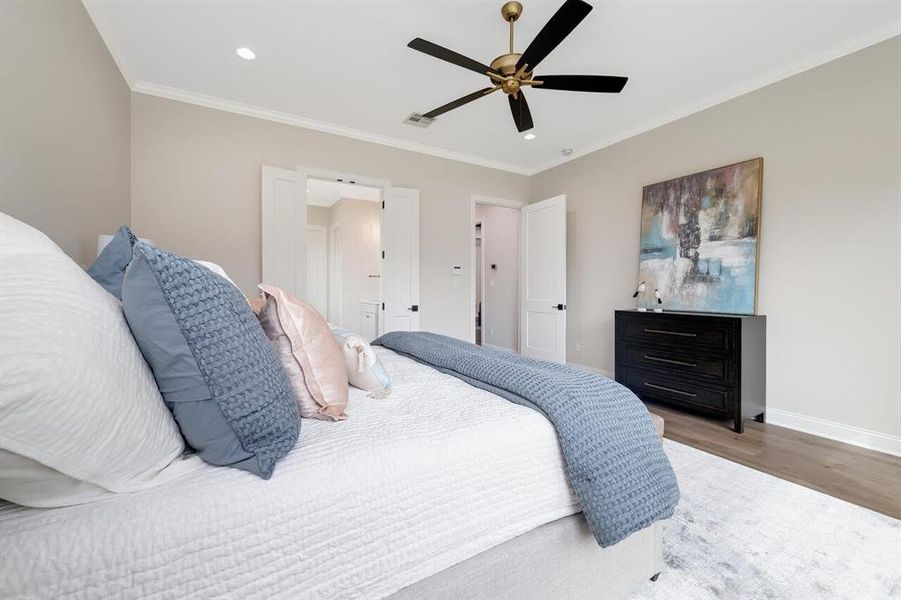 Bedroom with wood finished floors, recessed lighting, ornamental molding, and ceiling fan Bedroom with wood finished floors, recessed lighting, ornamental molding, and ceiling fan
