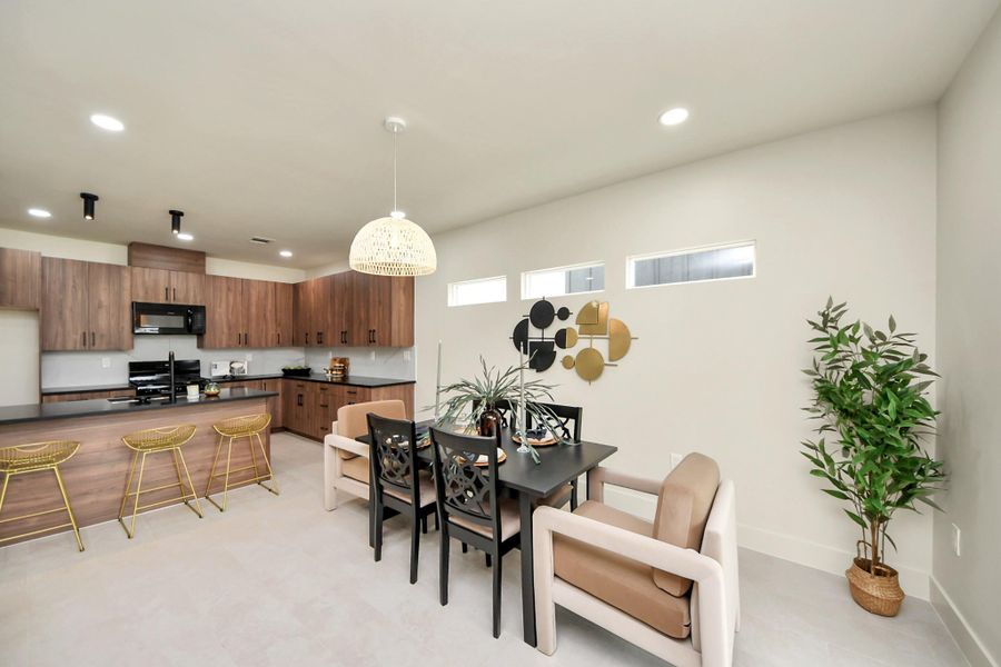 A seamless transition from the kitchen to the sun-filled dining area