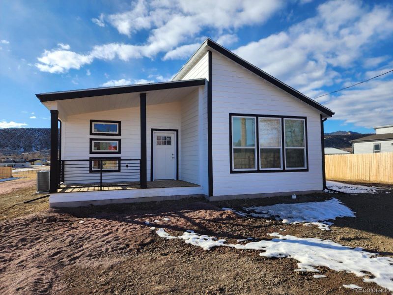Front exterior of a new home in , Cañon City, CO, highlighting curb appeal (Image 22).