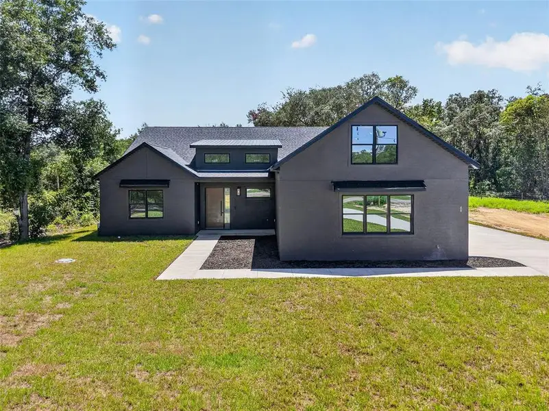 Front exterior of a new home in , Ocklawaha, FL, highlighting curb appeal (Image 2). Front exterior of a new home in , Ocklawaha, FL, highlighting curb appeal (Image 2).