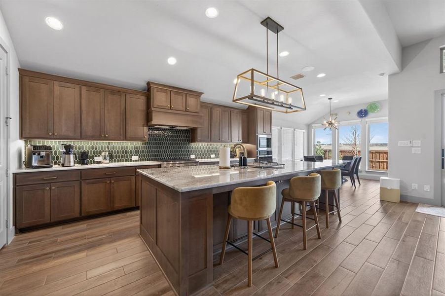 Designer chef’s kitchen with oversized quartz island and commercial-style gas rangetop. Designer chef’s kitchen with oversized quartz island and commercial-style gas rangetop.