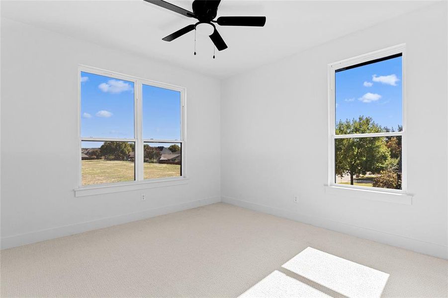 3rd Bedroom on the 2nd floor with light carpet and a ceiling fan 3rd Bedroom on the 2nd floor with light carpet and a ceiling fan