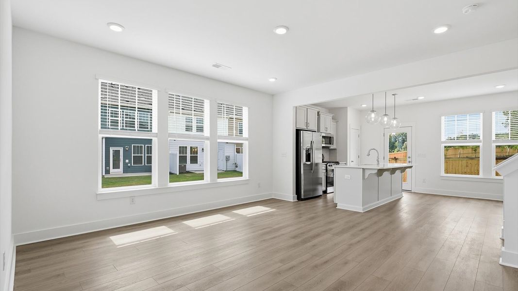 Spacious family room with rich hardwood flooring and elegant trim work in a reputable DRB Homes build