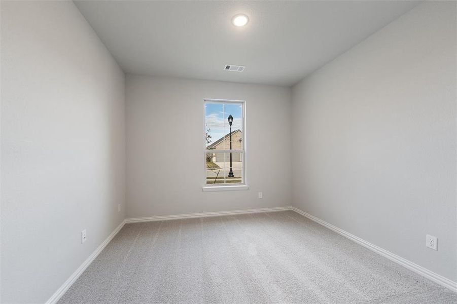 Empty room with light carpet and baseboards