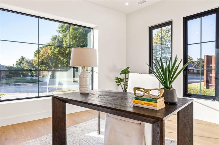 Office space featuring light wood-style flooring and recessed lighting Office space featuring light wood-style flooring and recessed lighting