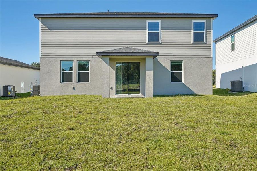 Exterior details and patio area of a home in The Reserve at Hammock Oaks - Signature Series, Lady Lake (Image 19).