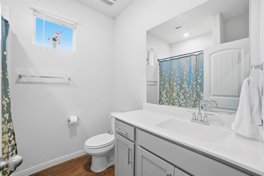 Full bath featuring vanity, dark wood finished floors, and a shower with curtain Full bath featuring vanity, dark wood finished floors, and a shower with curtain