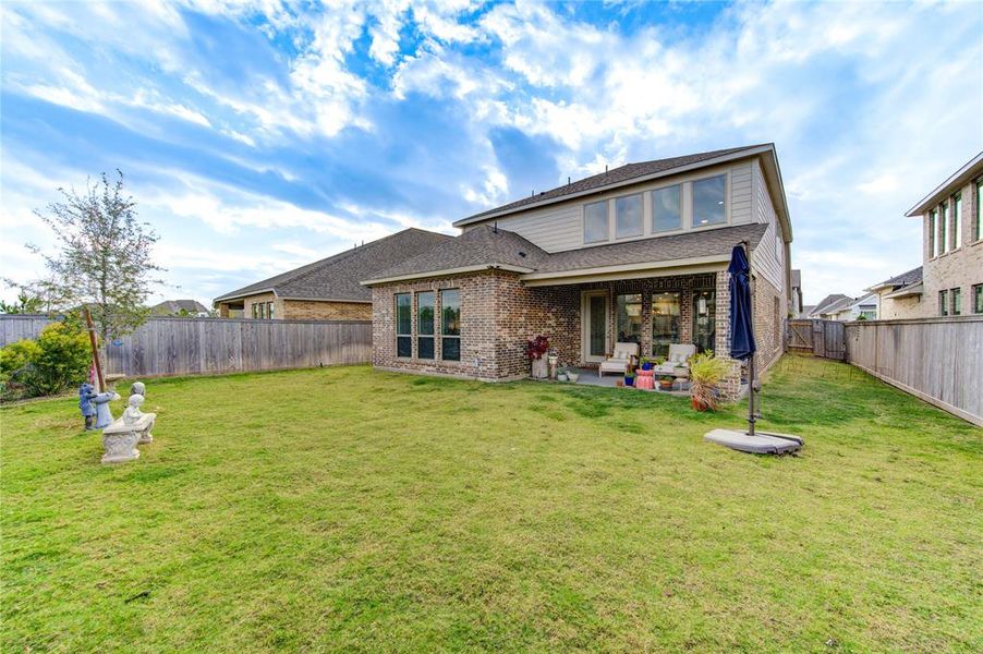 Expansive backyard offers ample space for outdoor entertainment.