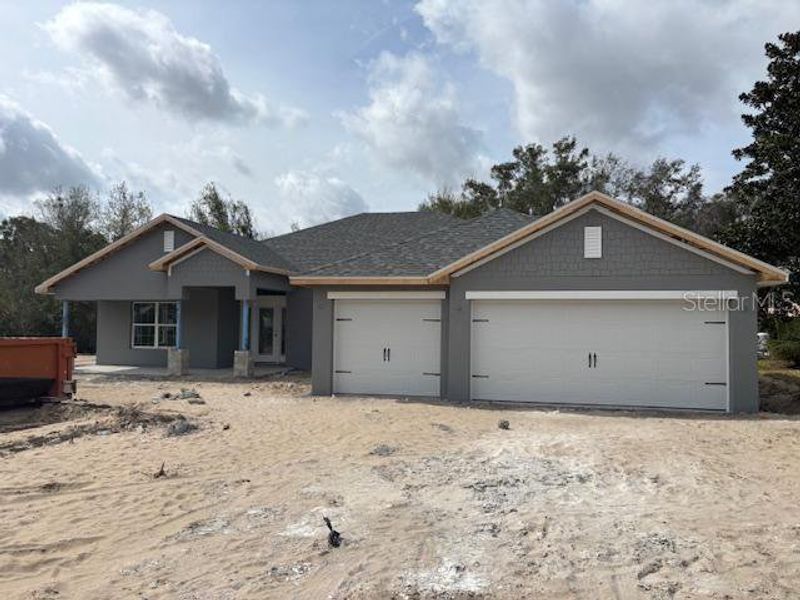 Front exterior of a new home in Juliette Falls, Dunnellon, FL, highlighting curb appeal (Image 2).