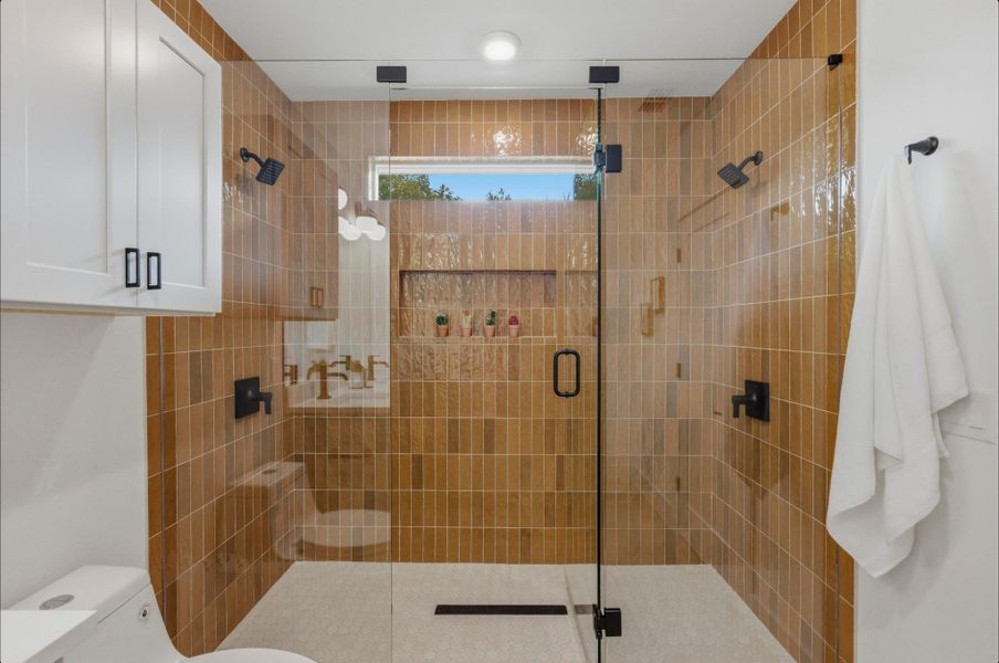 Bathroom featuring toilet and a stall shower