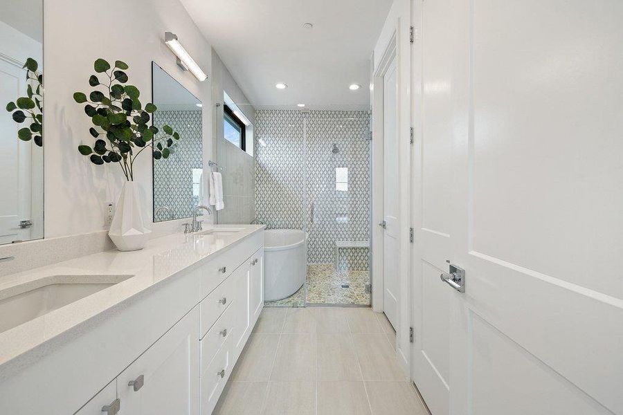 Spacious bathroom featuring a dual vanity with undermount sinks and light-toned countertops
