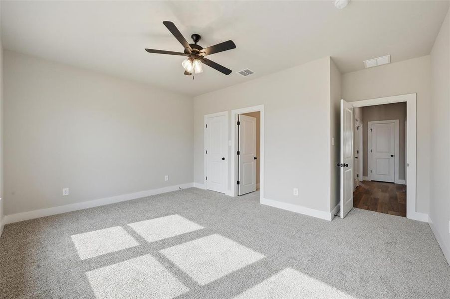 Unfurnished bedroom featuring carpet and ceiling fan
