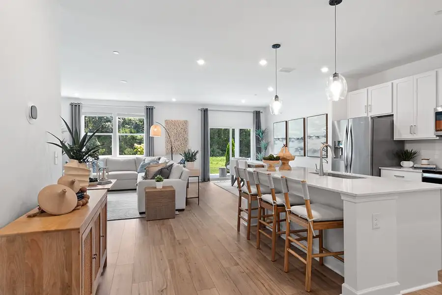 A kitchen with a dining table and couches.