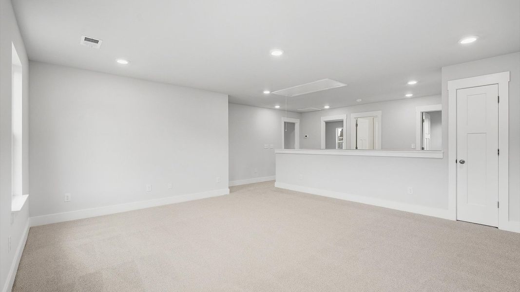 Stylish loft retreat with carpeted flooring and accomplished architectural detail by DRB Homes