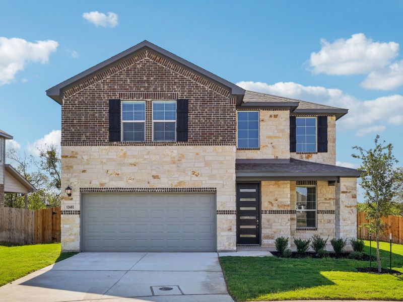 Front exterior of a new home in Carmel Ranch, Schertz, TX, highlighting curb appeal (Image 1).
