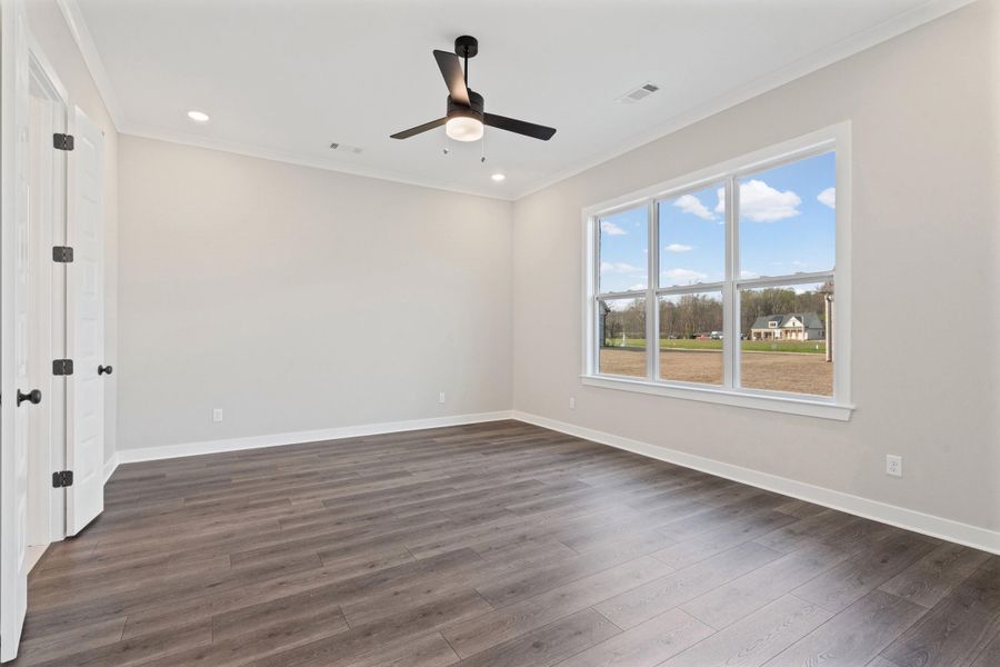 Empty room featuring crown molding, ceiling fan, dark wood finished floors, and recessed lighting