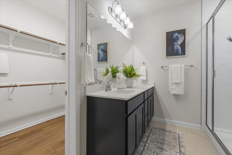 The walk-in closet is tucked behind the bathroom.