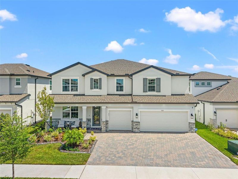 Front exterior of a new home in Whispering Oaks Preserve, Wesley Chapel, FL, highlighting curb appeal (Image 2).