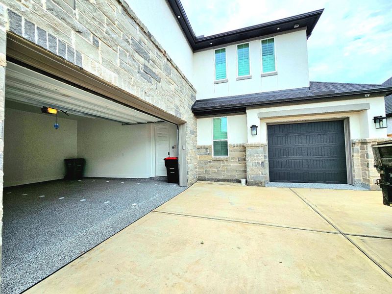 This home features a spacious two-car garage on the left and a single-car garage on the right, perfect for storing a golf cart in our golf course community.