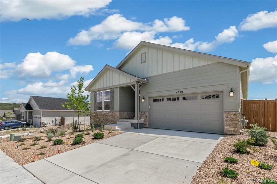 Front exterior of a new home in Terrain Oak Valley, Castle Rock, CO, highlighting curb appeal (Image 2).