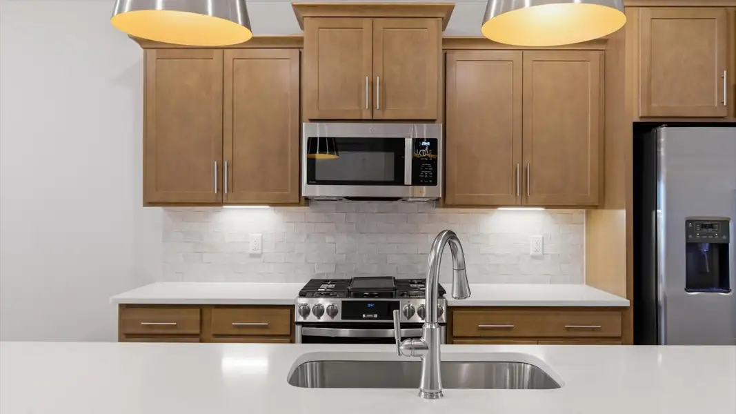 Exceptional kitchen featuring a spacious island, eye-catching pendant lights, and modern finishes located in Greenville, SC