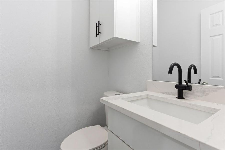Half bath with vanity and toilet Half bath with vanity and toilet