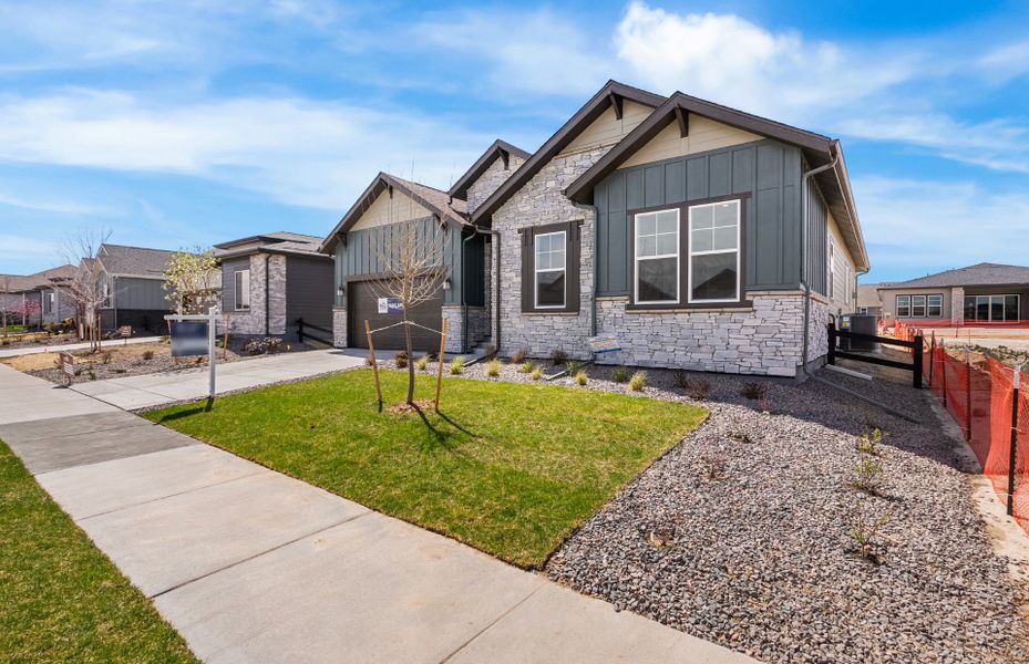 Front exterior of a new home in Hilltop at Inspiration, Aurora, CO, highlighting curb appeal (Image 25).