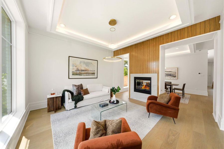 This light and bright front room is great for relaxing with friends and family, nearby the dining room. Cozy fireplace and huge window give this space a comfortable ambiance. This light and bright front room is great for relaxing with friends and family, nearby the dining room. Cozy fireplace and huge window give this space a comfortable ambiance.