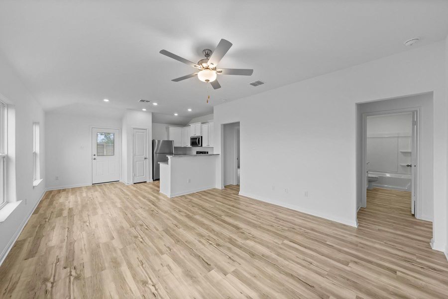 Unfurnished living room with recessed lighting, light wood-style flooring, and ceiling fan