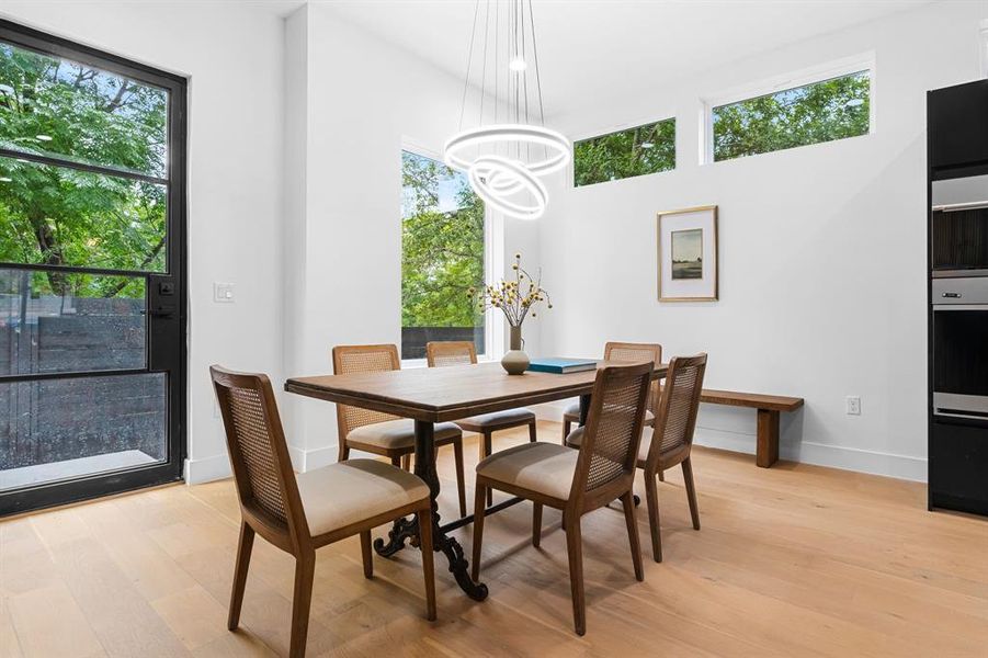 Dedicated dining area just off the kitchen with back door with ramp access from the alley