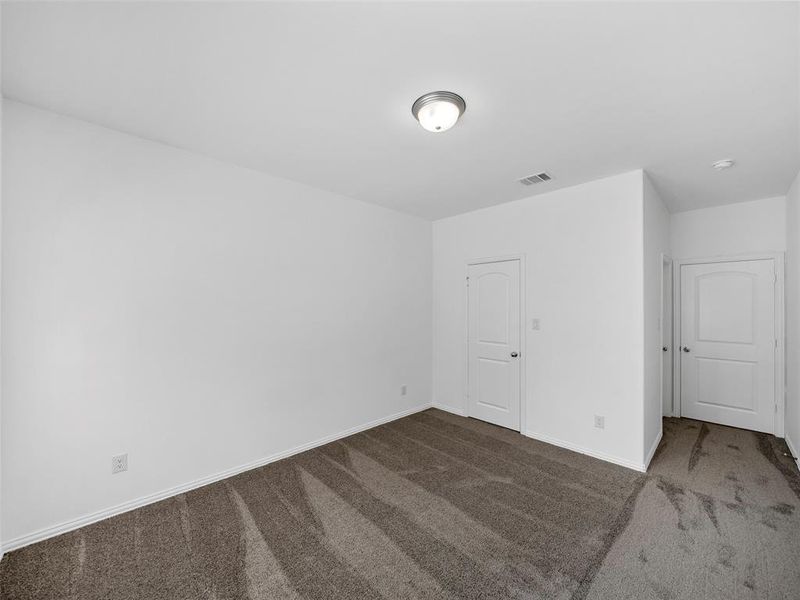 Spare room with dark colored carpet